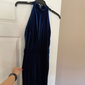 Long blue velvet key-hole cutout halter jumpsuit with mesh sides and zipper back